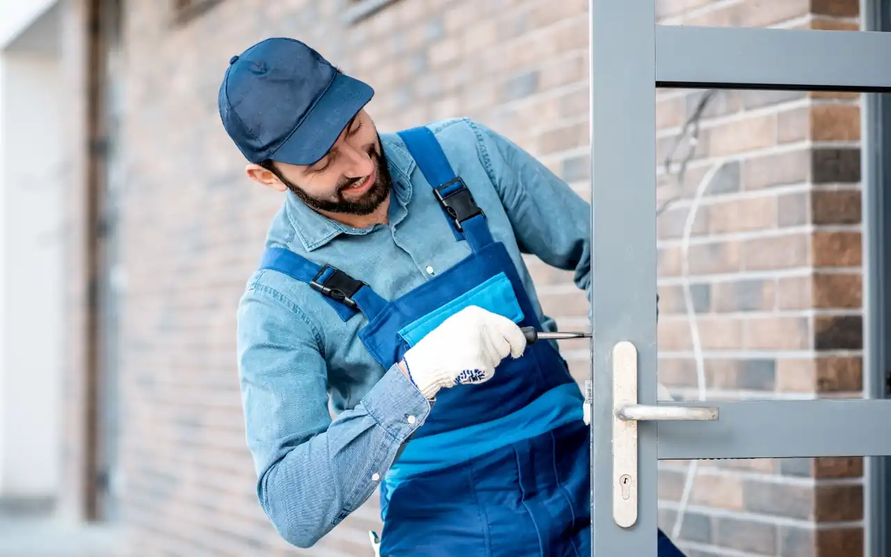 Professional repairing an aluminum door, ensuring security and functionality.