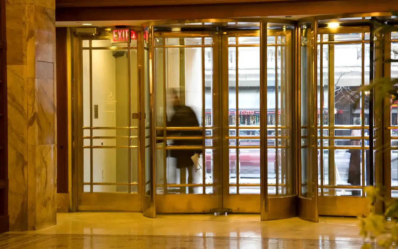 Customer entering a commercial building through a revolving door.