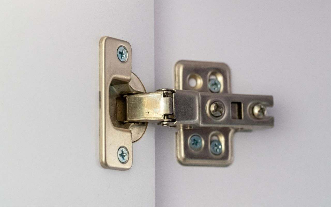 Close-up of a loose hinge on a commercial door.