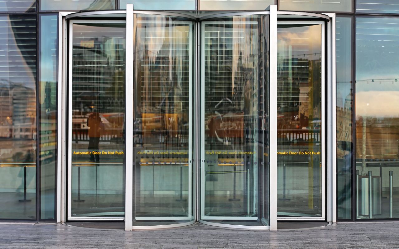 A professional technician repairing a commercial door in a Chicago office building.